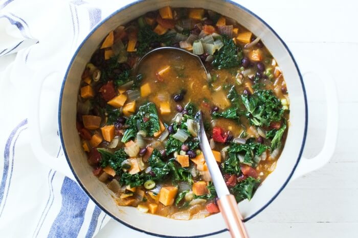 Hearty Sweet Potato Kale Soup |  A couple is cooking