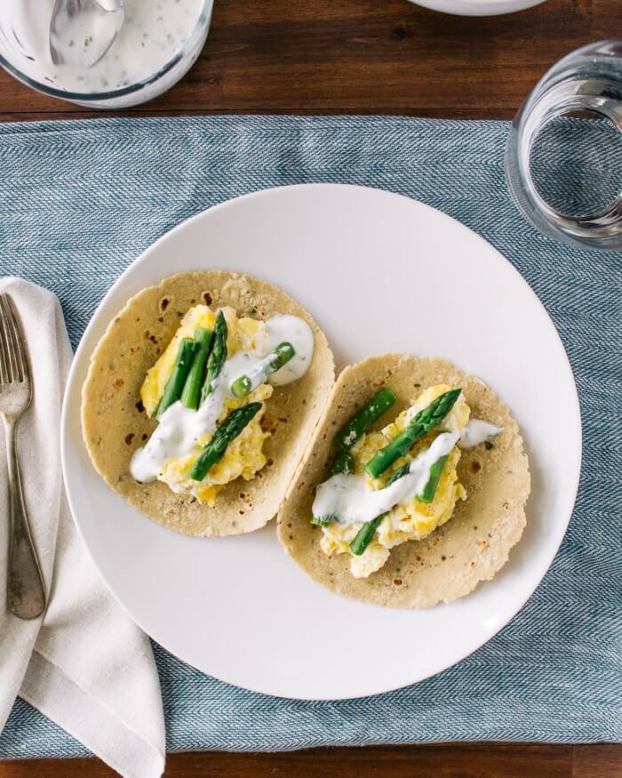 Scrambled Egg Tacos with Ricotta and Asparagus |  A couple is cooking 