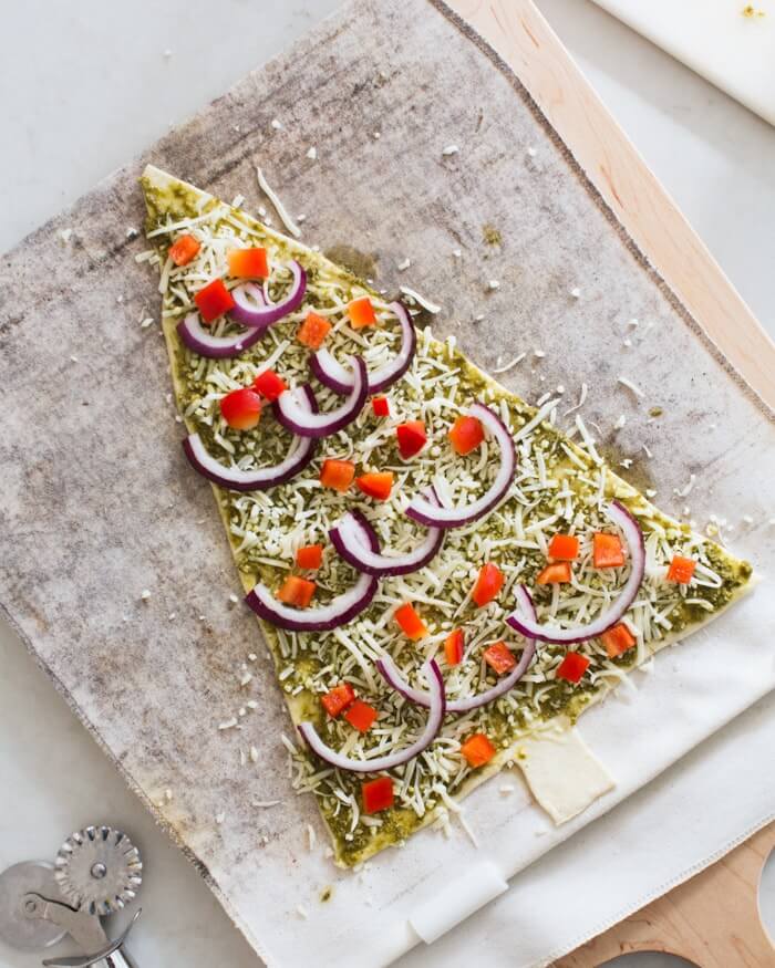 Pesto Christmas Tree Pizzas |  A couple is cooking