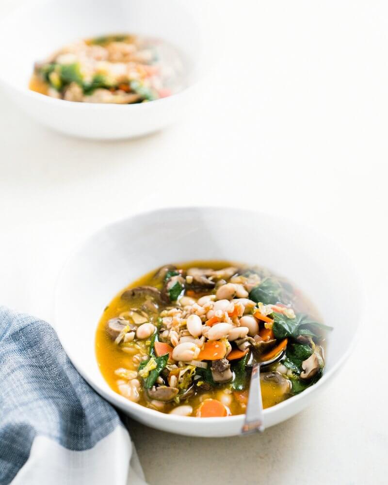 Cozy Farro and Brussels Sprout Soup |  A couple is cooking