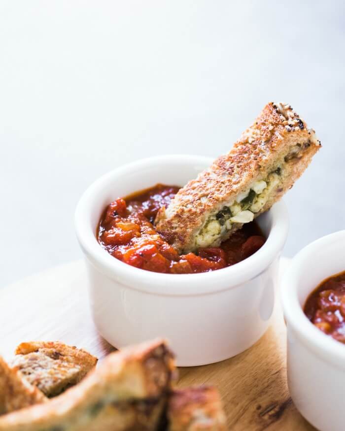 Pesto Grilled Cheese Dips with Marinara Sauce |  A couple is cooking