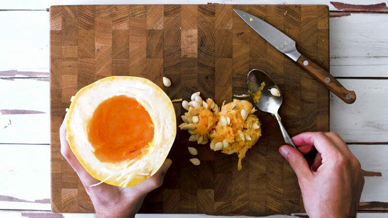 How to cut spaghetti squash: Use a spoon to scoop out the seeds