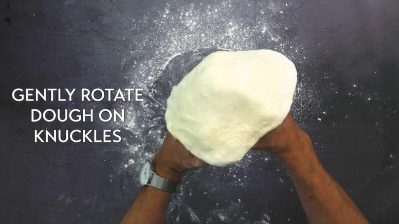 Step 3: Place the dough over your knuckles and gently roll around