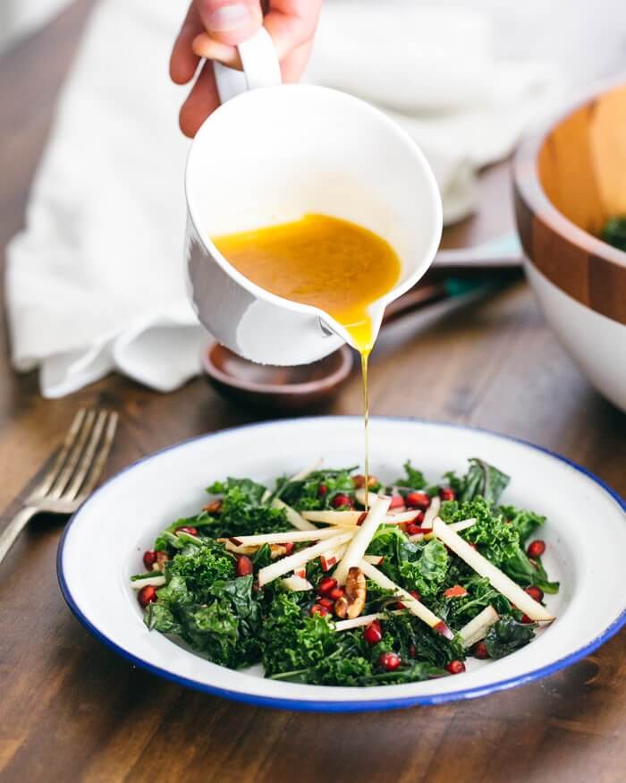 Kale salad with apple and pomegranate massage |  A couple is cooking