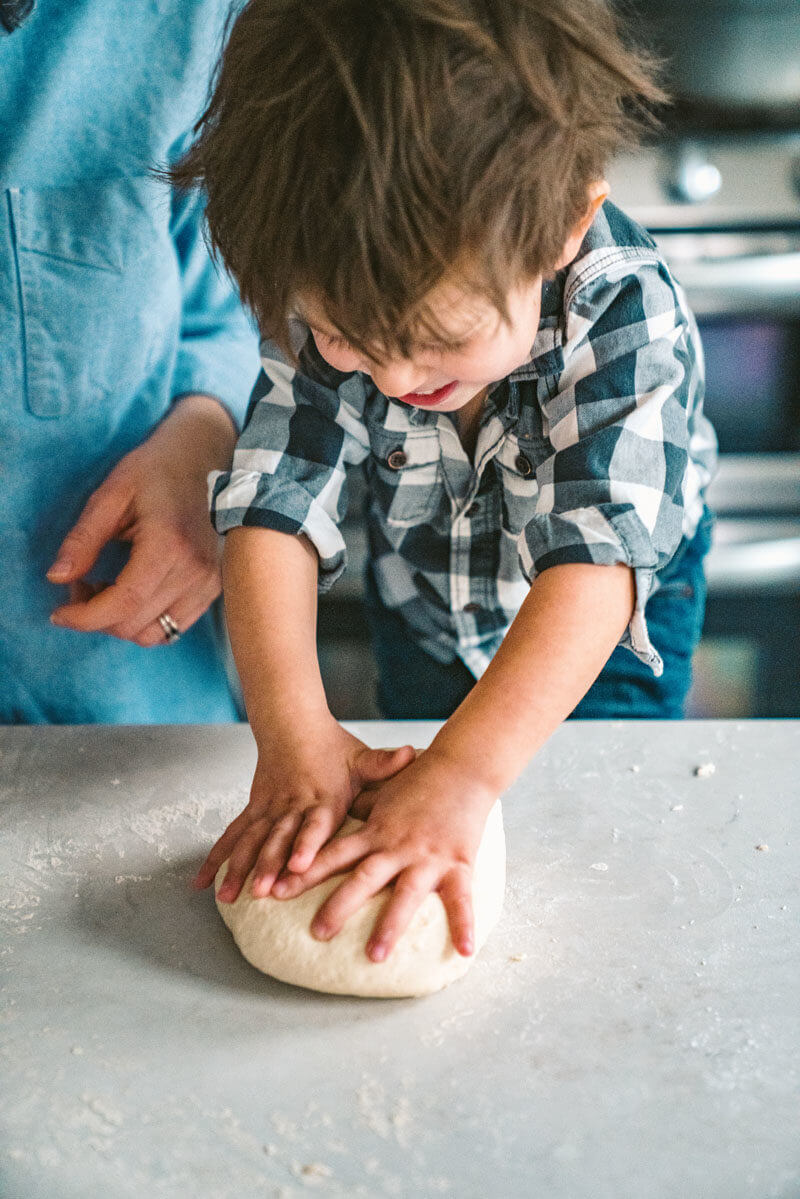 Child kneads dough