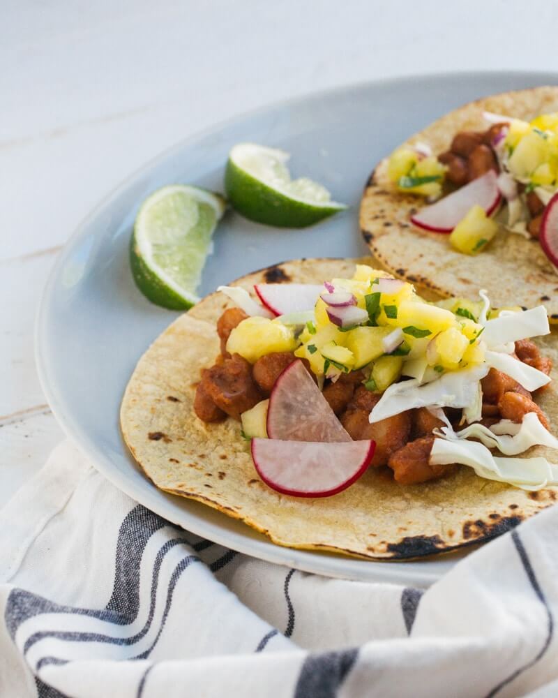 BBQ Bean Tacos with Pineapple Salsa |  A couple is cooking
